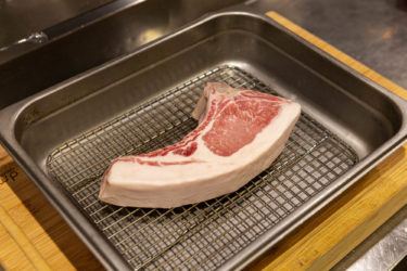 Berkshire pork chop resting in pan